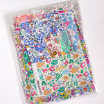 Curated scrap bags containing an assortment of adorable Hello Kitty x Liberty Japan Tana Lawn pieces, ranging in sizes from 6-25cm in diameter (2.5"-10").