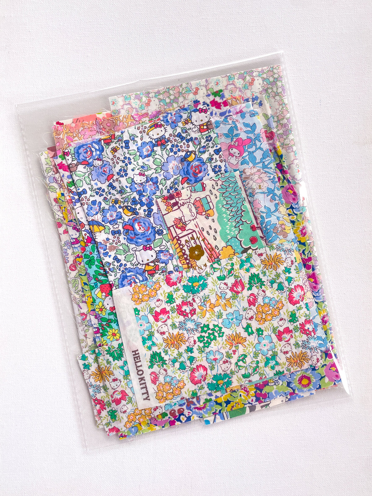 Curated scrap bags containing an assortment of adorable Hello Kitty x Liberty Japan Tana Lawn pieces, ranging in sizes from 6-25cm in diameter (2.5"-10").