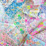Curated scrap bags containing an assortment of bright neon Liberty Tana Lawn pieces, ranging in sizes from 6-25cm in diameter (2.5"-10").
