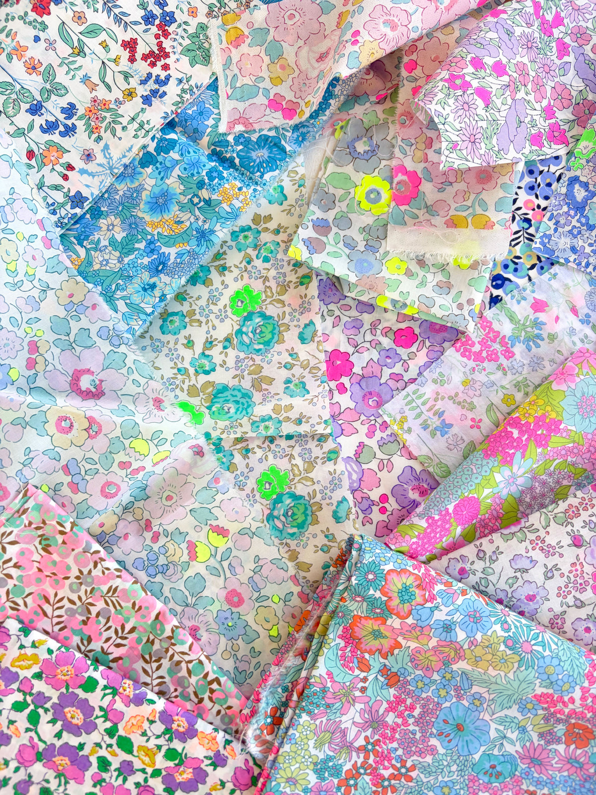Curated scrap bags containing an assortment of bright neon Liberty Tana Lawn pieces, ranging in sizes from 6-25cm in diameter (2.5"-10").