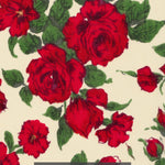 A romantic and timeless Liberty rose print fabric from the 1990s. Carline has richly detailed deep red roses with dark green leaves scattered across a cream background.