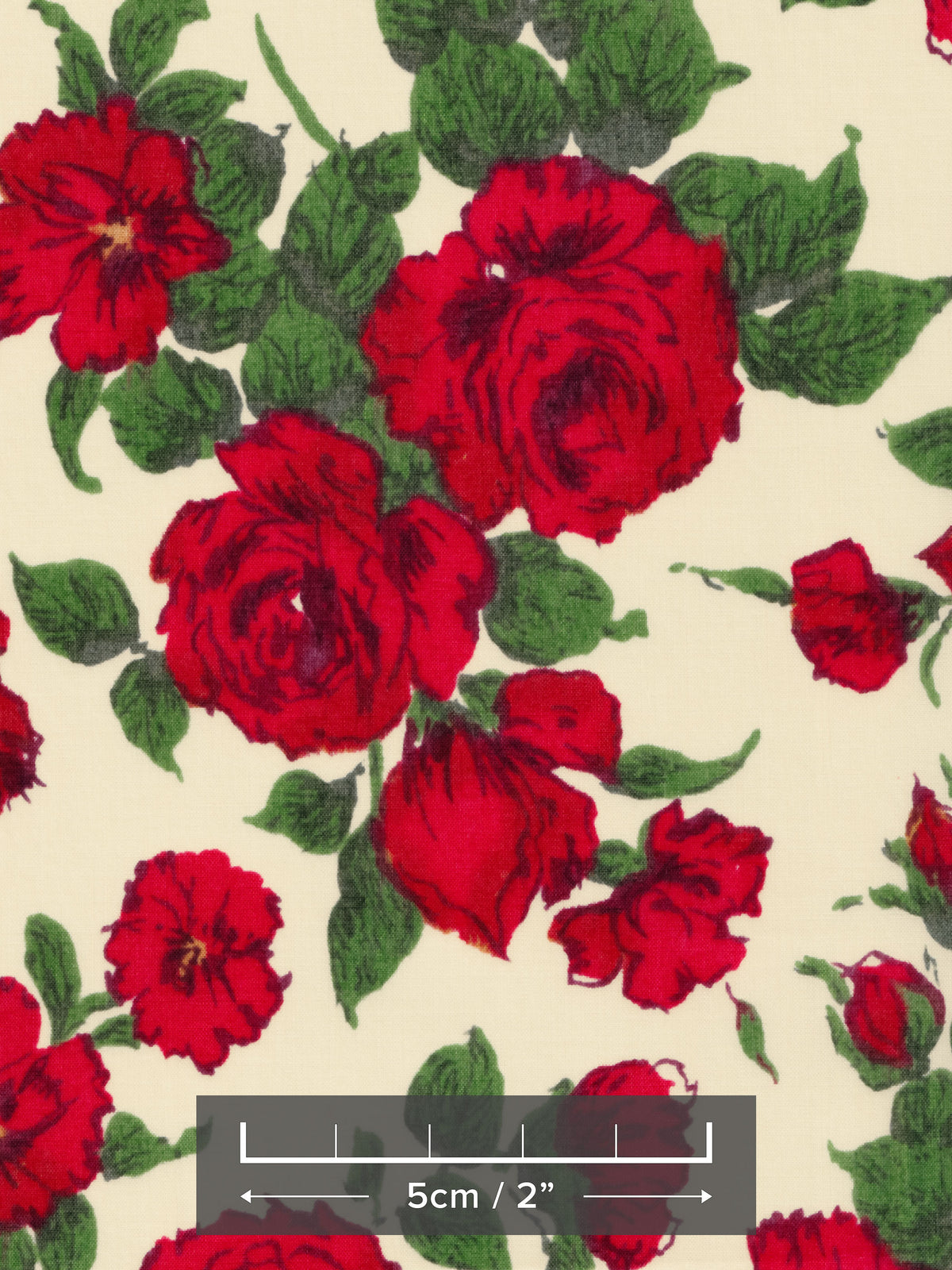 A romantic and timeless Liberty rose print fabric from the 1990s. Carline has richly detailed deep red roses with dark green leaves scattered across a cream background.