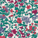 A rare vintage Clover floral Liberty print from the 1980s, with a sweet wildflower print in shades of blue, red, and deep green on a warm white background.