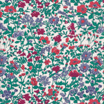 A rare vintage Clover floral Liberty print from the 1980s, with a sweet wildflower print in shades of blue, red, and deep green on a warm white background.