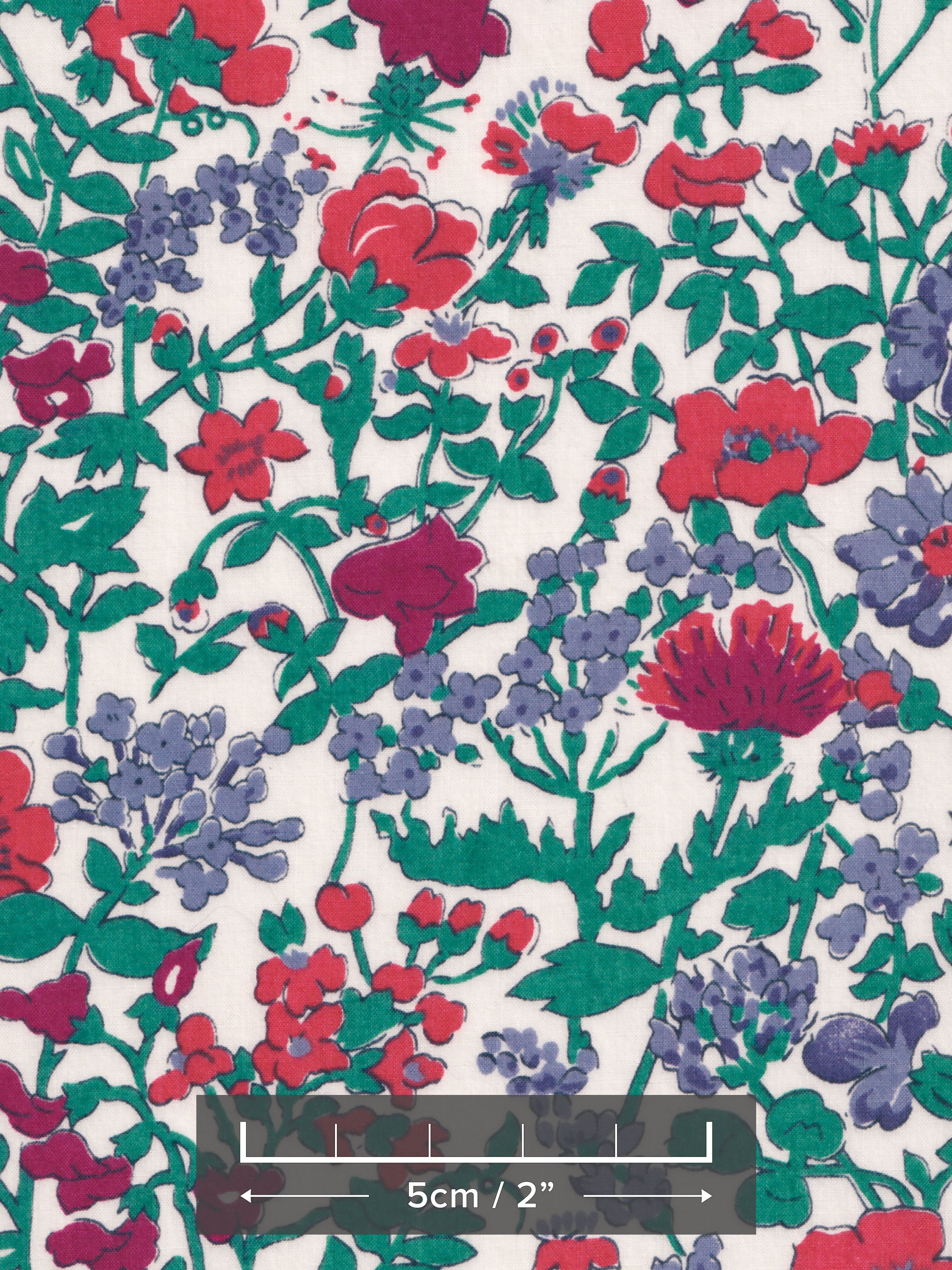 A rare vintage Clover floral Liberty print from the 1980s, with a sweet wildflower print in shades of blue, red, and deep green on a warm white background.