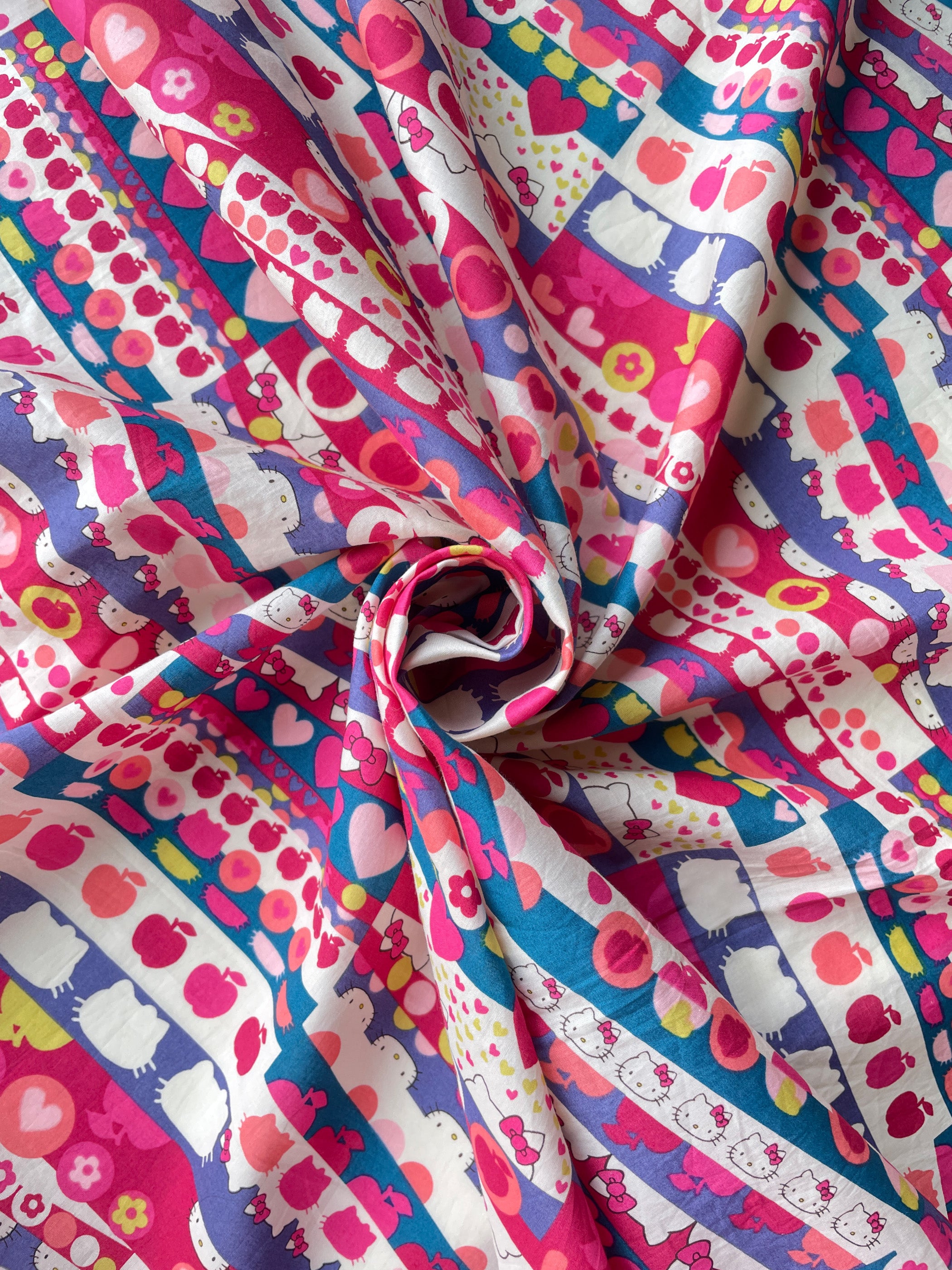 A geometric print from one of Liberty Japan's earliest collaborations with Hello Kitty, this vibrant print would be perfect for a little girl's garment.