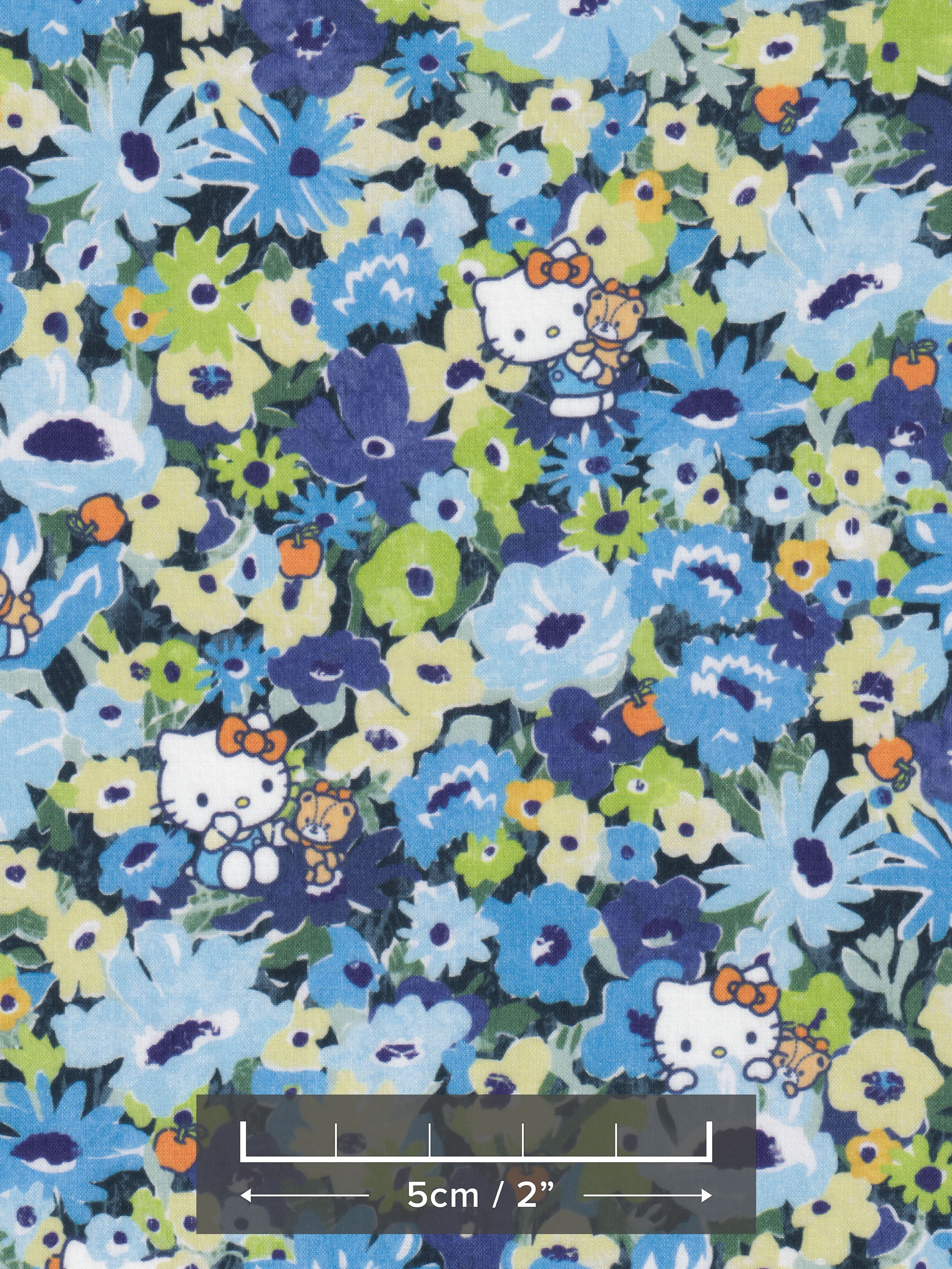 This print from the newest Liberty Japan x Hello Kitty collaboration is a twist on the much-loved classic Liberty print Thorpe. Hello Kitty and her teddy play hide-and-seek in a meadow of flowers in blues and greens.