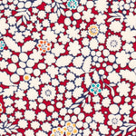 A delightful but rare print, Kathy is a cherry red and warm white floral with little pops of aqua and yellow.
