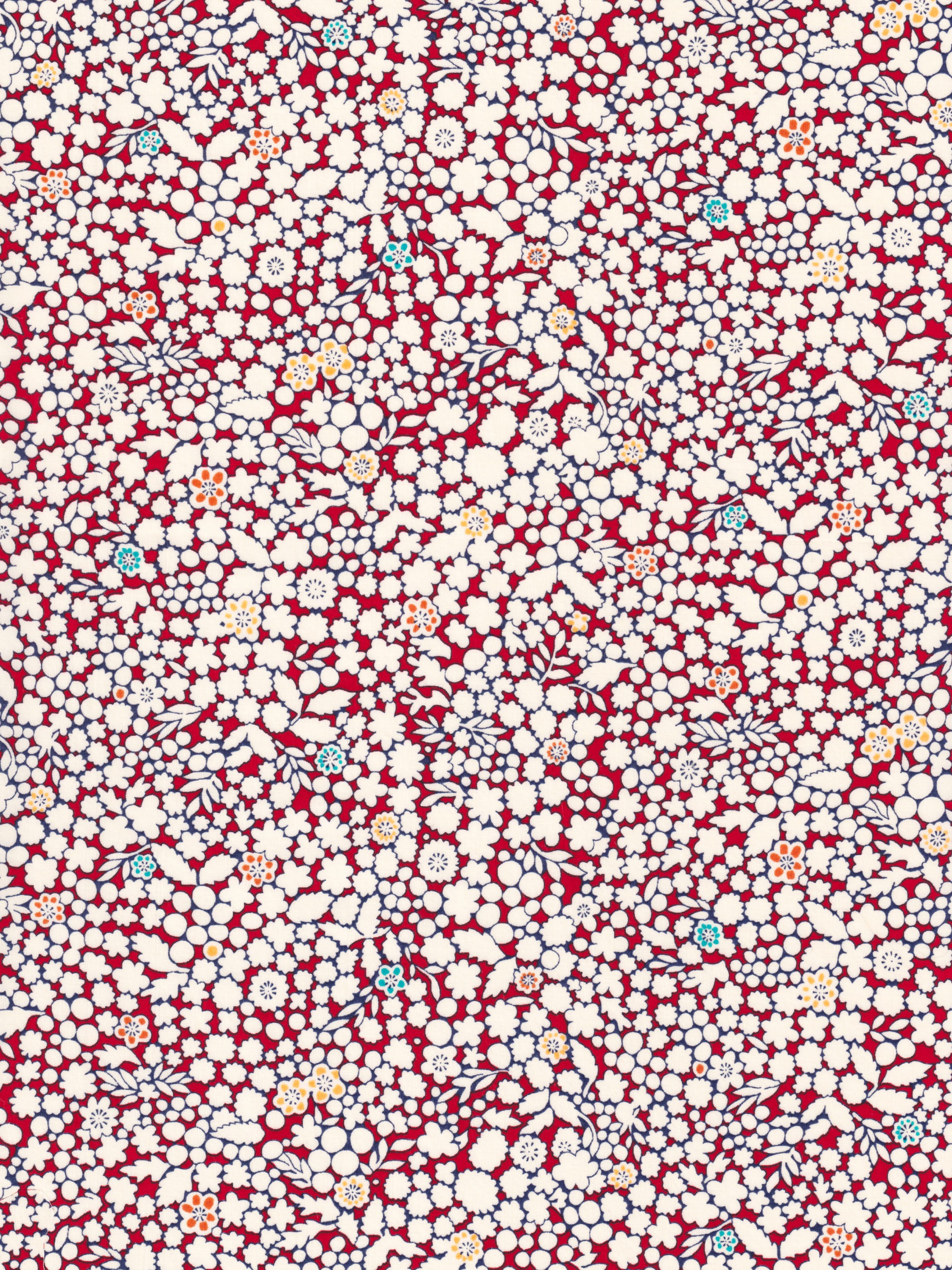 A delightful but rare print, Kathy is a cherry red and warm white floral with little pops of aqua and yellow.