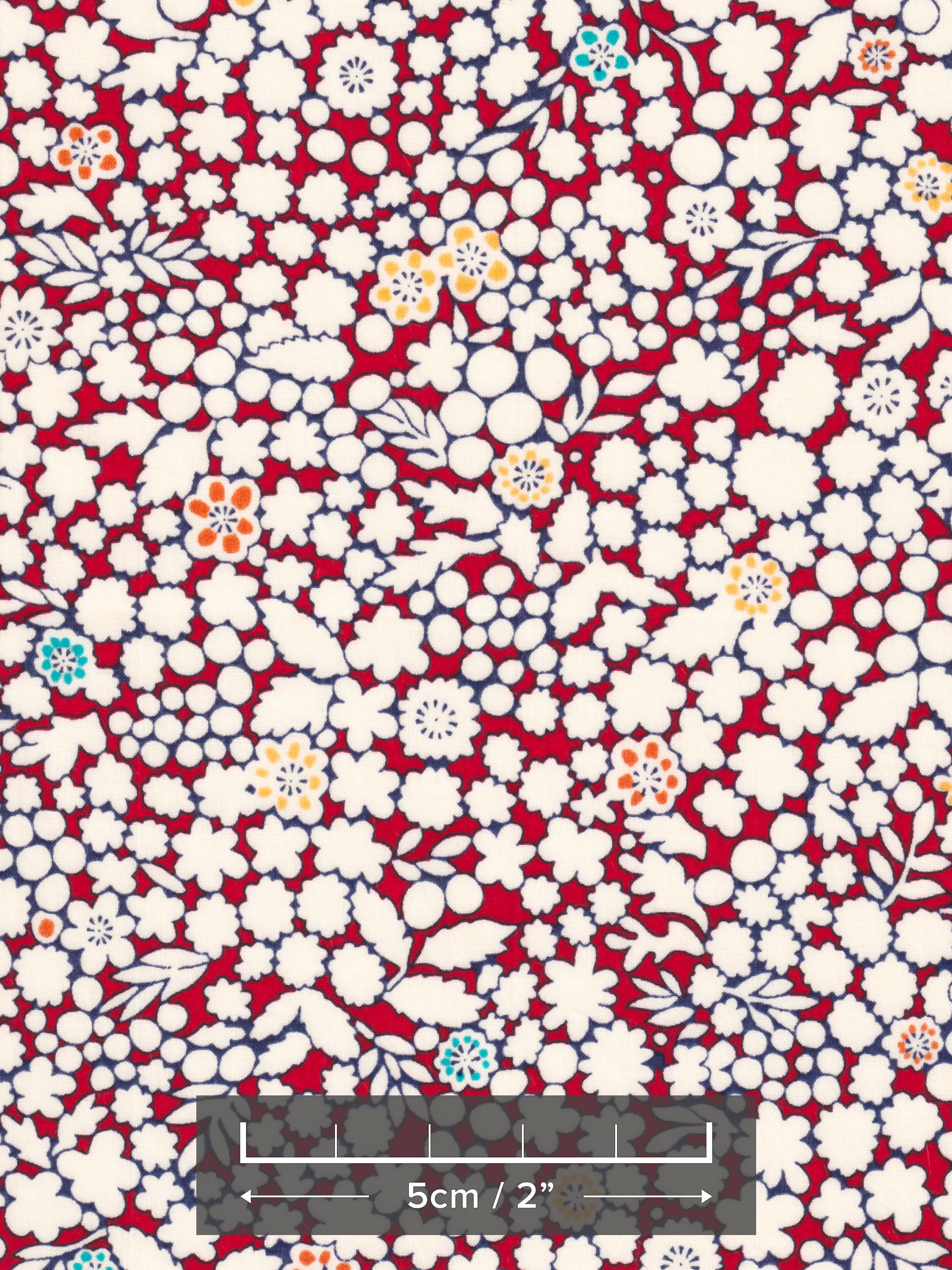 A delightful but rare print, Kathy is a cherry red and warm white floral with little pops of aqua and yellow.