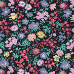 Channel the electric colours of the 1980s with this original Liberty Pyretheum Daisy print. Red, purple, blue, green, and yellow flowers pop against a blackground. 