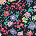 Channel the electric colours of the 1980s with this original Liberty Pyretheum Daisy print. Red, purple, blue, green, and yellow flowers pop against a blackground. 