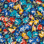 An old unnamed Liberty floral print with rich blue, red, and mustard yellow flowers on a navy background. A lovely rare fabric for Liberty collectors!