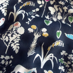 Yoshie is a novelty Liberty Japan print with cute woodland critters like stags, owls, and bunny rabbits. This print has metallic gold accents which are striking against the mottled navy background.